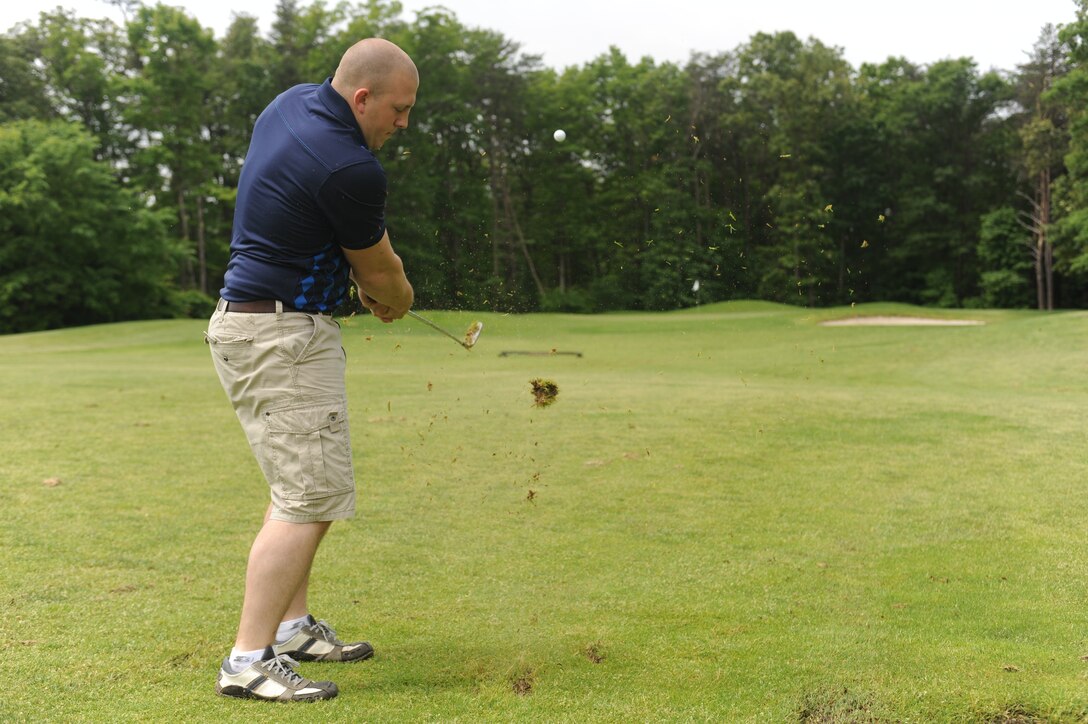 Jake Oldham uses a pitching wedge to lob a ball up on the green during the MCCS Spring Golf Tournament aboard Andrews Air Base May 19. Oldham’s team finished the tournament with an overall score of +5 over par. (Photo by Cpl. Joseph Cabrera).